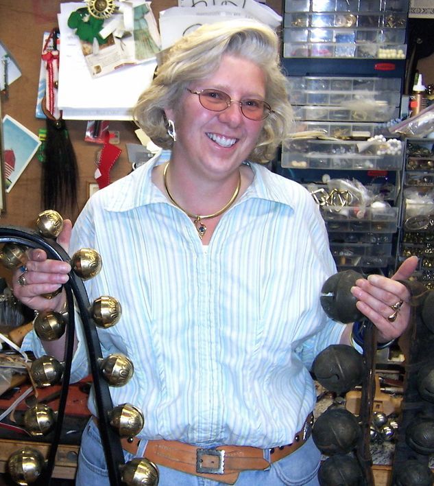 Diane Louise Paul holding her handmade bell sets.